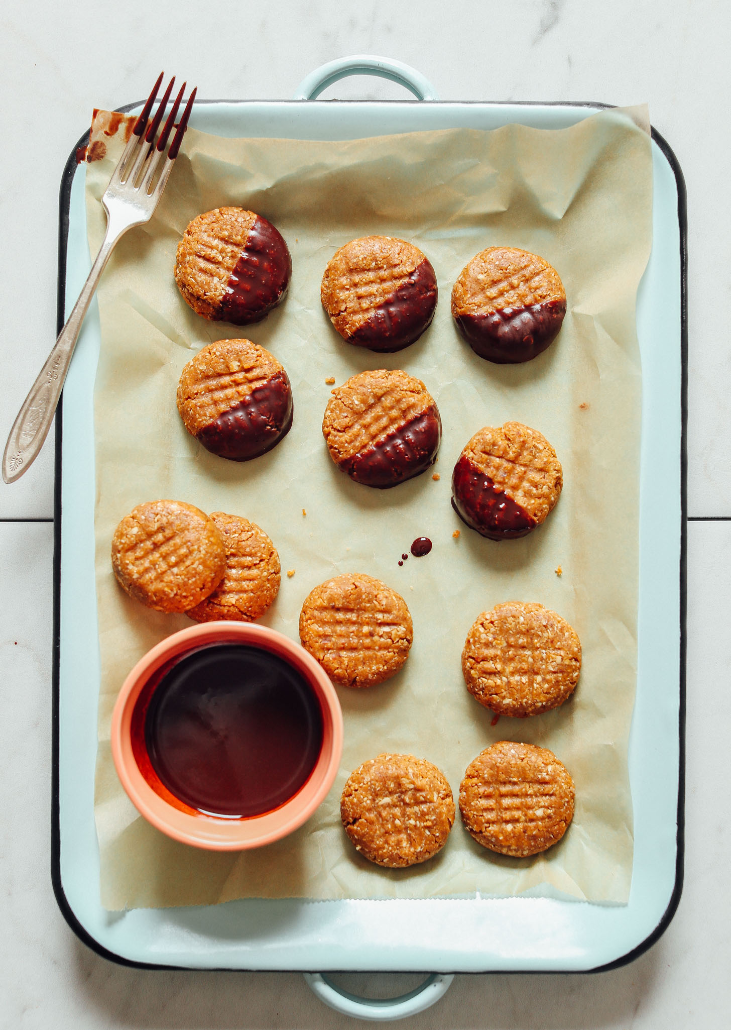 Dipping some of our 3-Ingredient Peanut Butter Cookies into homemade vegan chocolate sauce