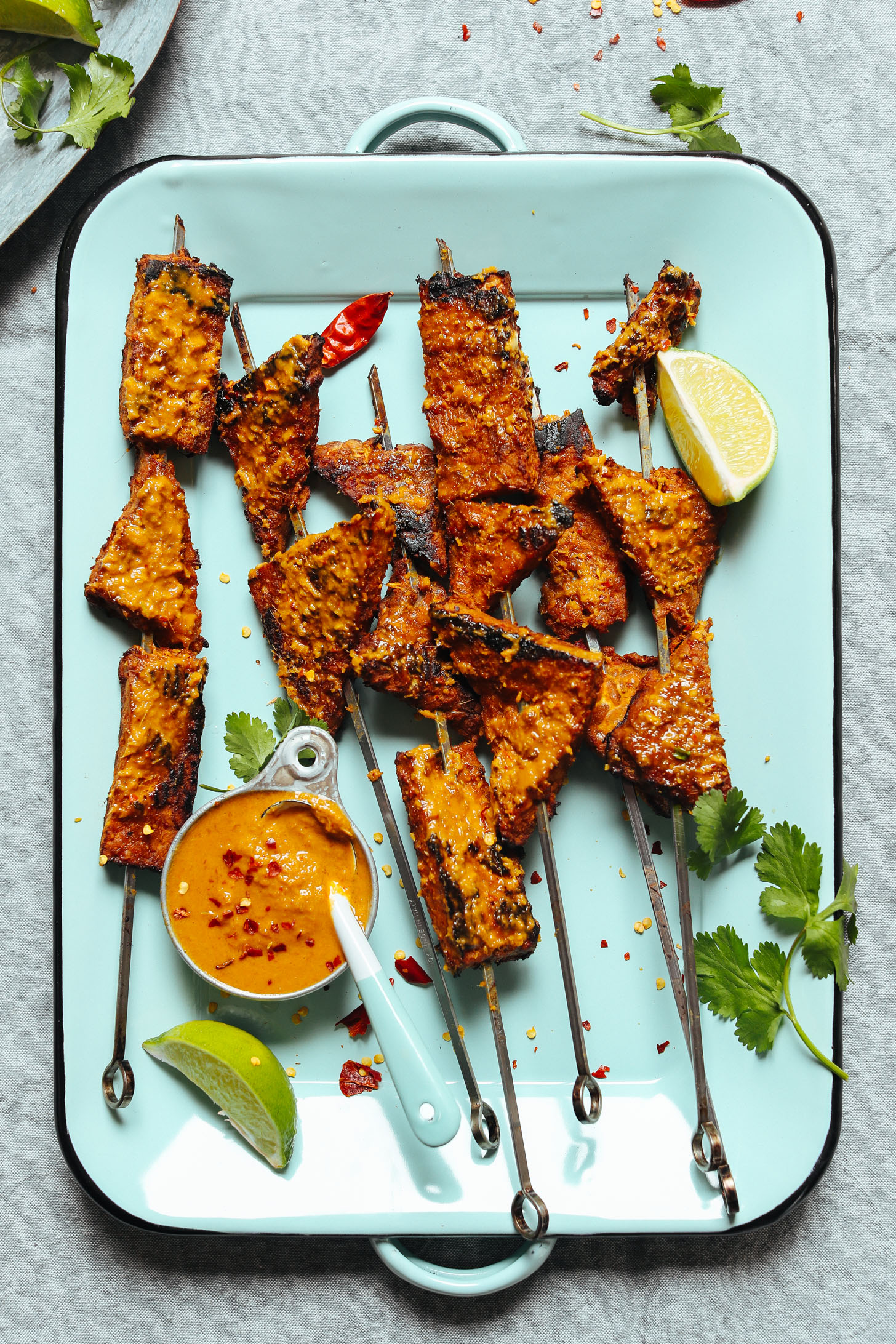 Blue platter filled with Lemongrass Tempeh Satay skewers for a delicious vegan protein dish