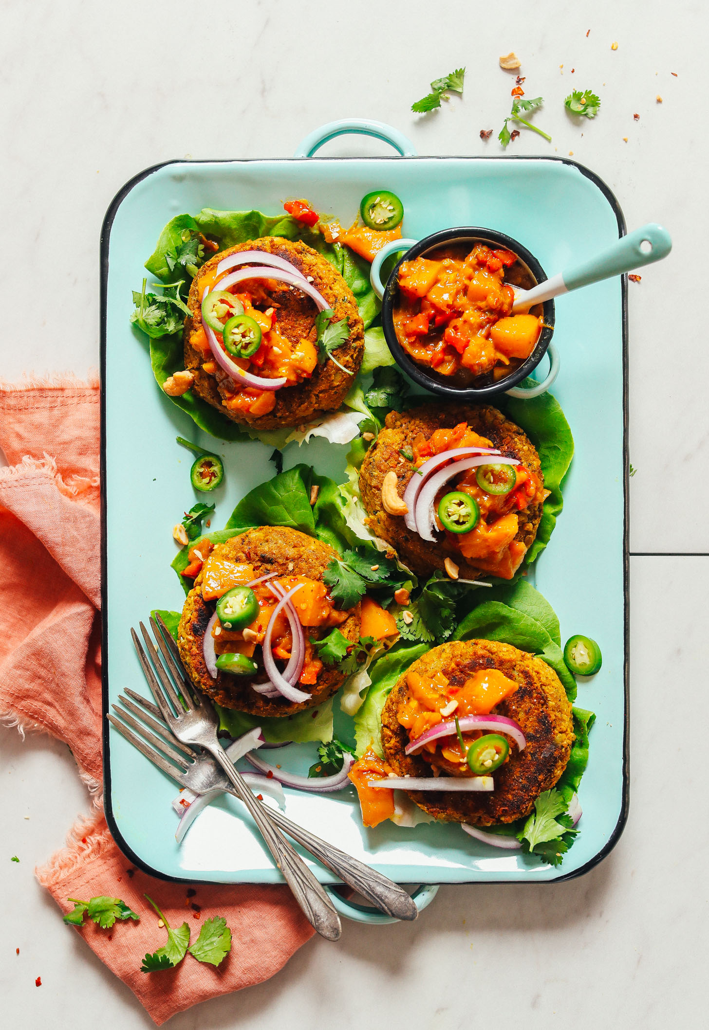 Platter filled with delicious Curried Chickpea Burgers on butter lettuce leaves