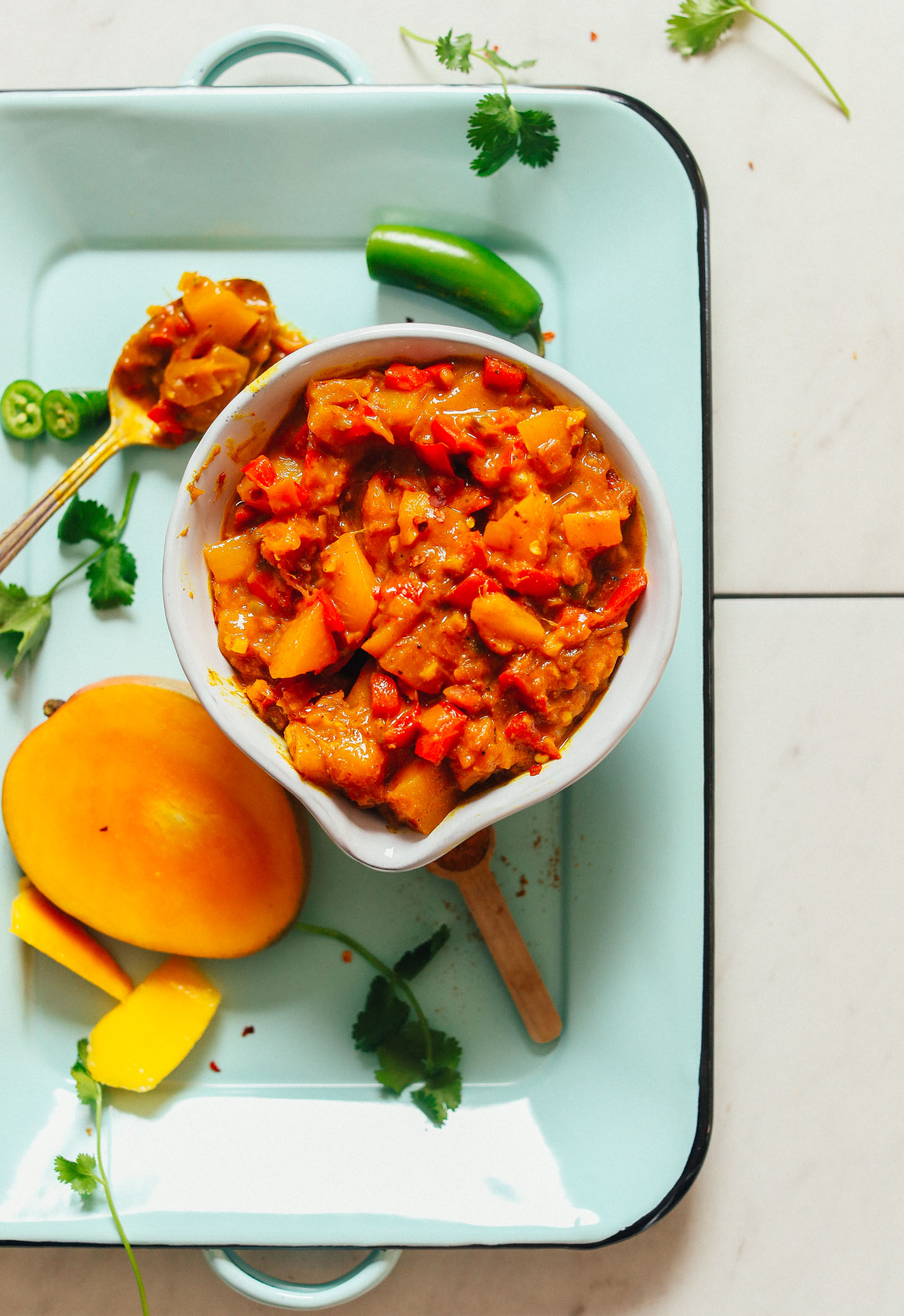 Platter with mango, cilantro, and serrano, and a big bowl of our Spicy Mango Chutney recipe