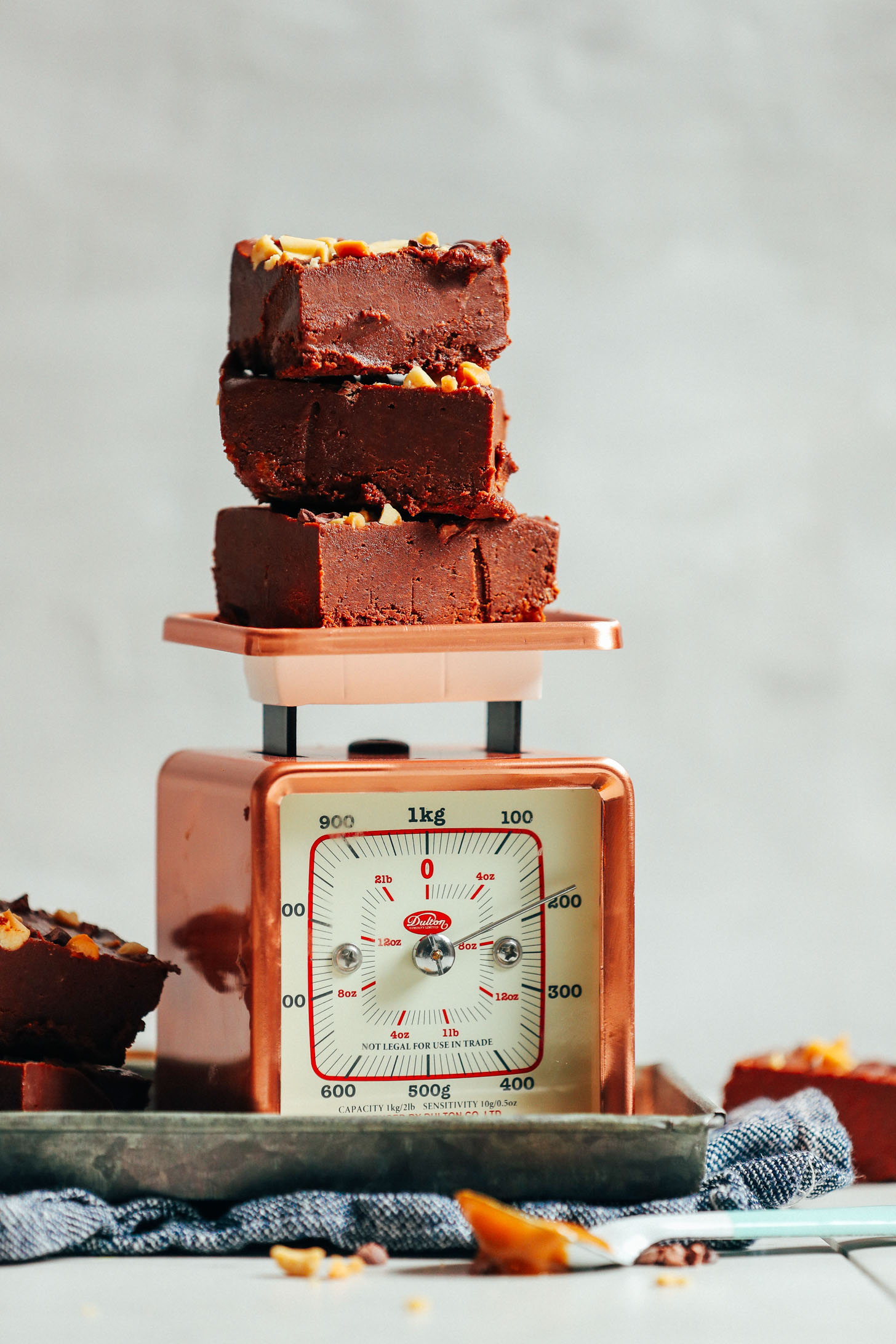 Vintage scale with a stack of 4-Ingredient Vegan Chocolate Peanut Butter Fudge