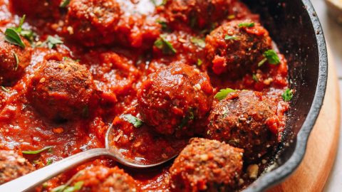 Cast-iron skillet filled with a batch of our delicious vegan meatball recipe