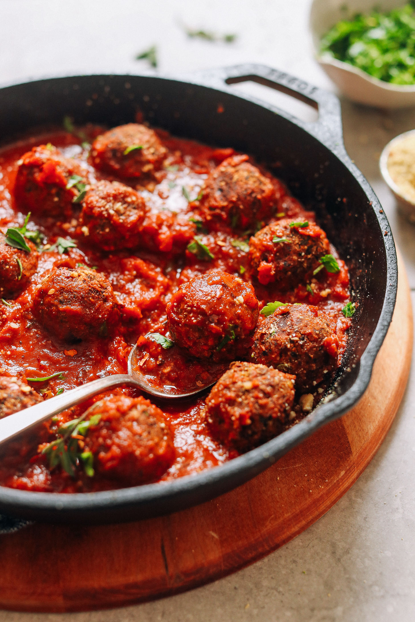 Cast-iron skillet filled with a batch of our delicious vegan meatball recipe