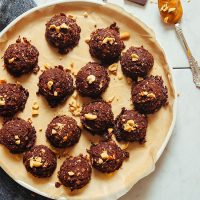 Parchment-lined plate of Vegan Chocolate Peanut Butter No Bake Cookies