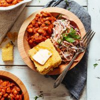 Wood bowl of our Vegan BBQ Bowl with Baked Beans, Coleslaw, and GF Cornbread