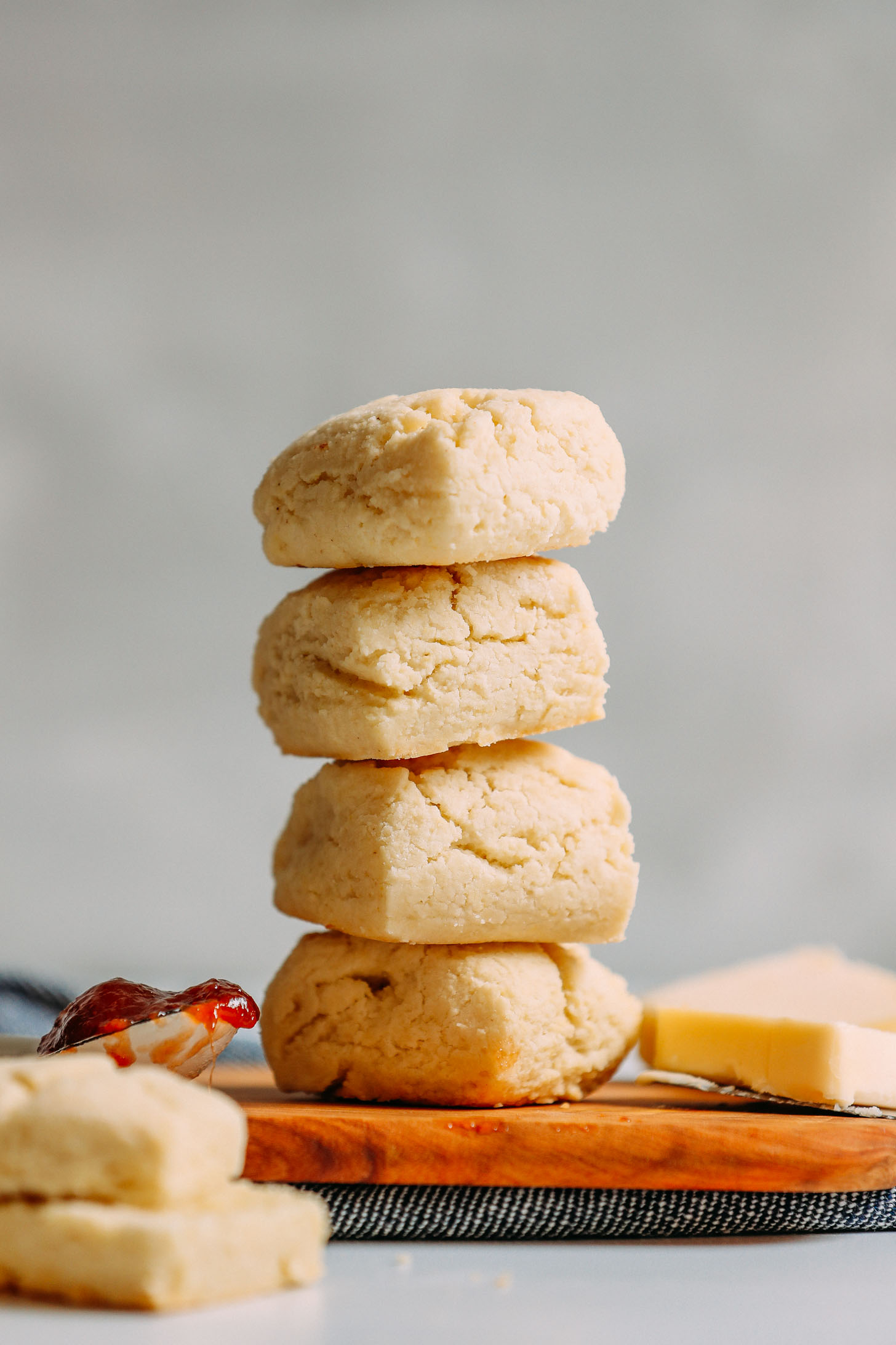 Stack of Vegan Gluten-Free Biscuits with a spoonful of jam and a slice of butter