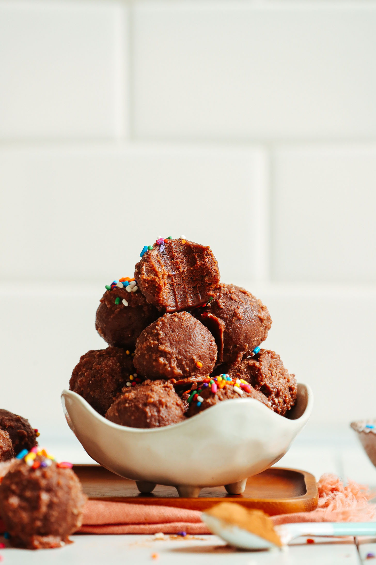 Bowl of Vegan Chocolate Cake Bites topped with colorful sprinkles