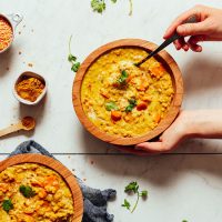Using a spoon to grab a bite of our delicious 1-pot Golden Curried Lentil Soup