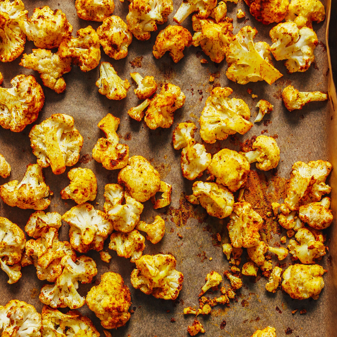 Parchment-lined baking sheet filled with Curry Roasted Cauliflower