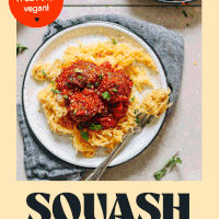 Plate of cheesy spaghetti squash pasta topped with vegan meatballs and marinara