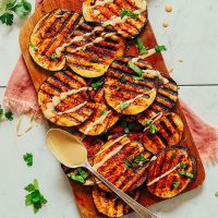 Slices of Smoky Grilled Eggplant on a cutting board