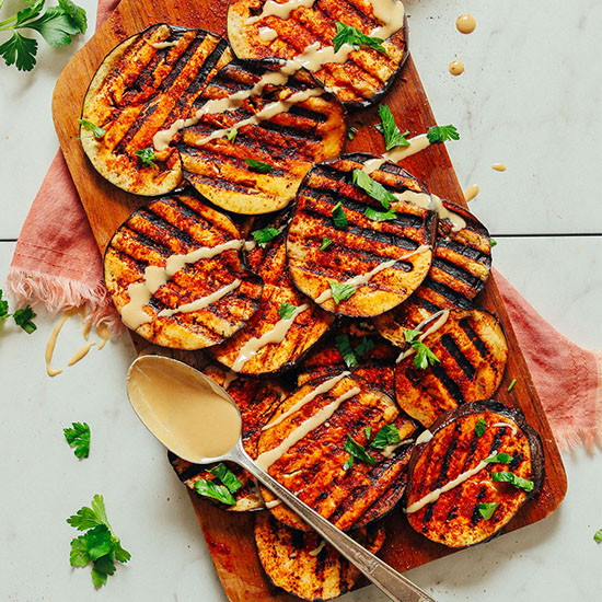 Smoky grilled eggplant slices on a cutting board