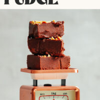 Slices of chocolate peanut butter freezer fudge resting on a scale with text above it saying just 4 ingredients