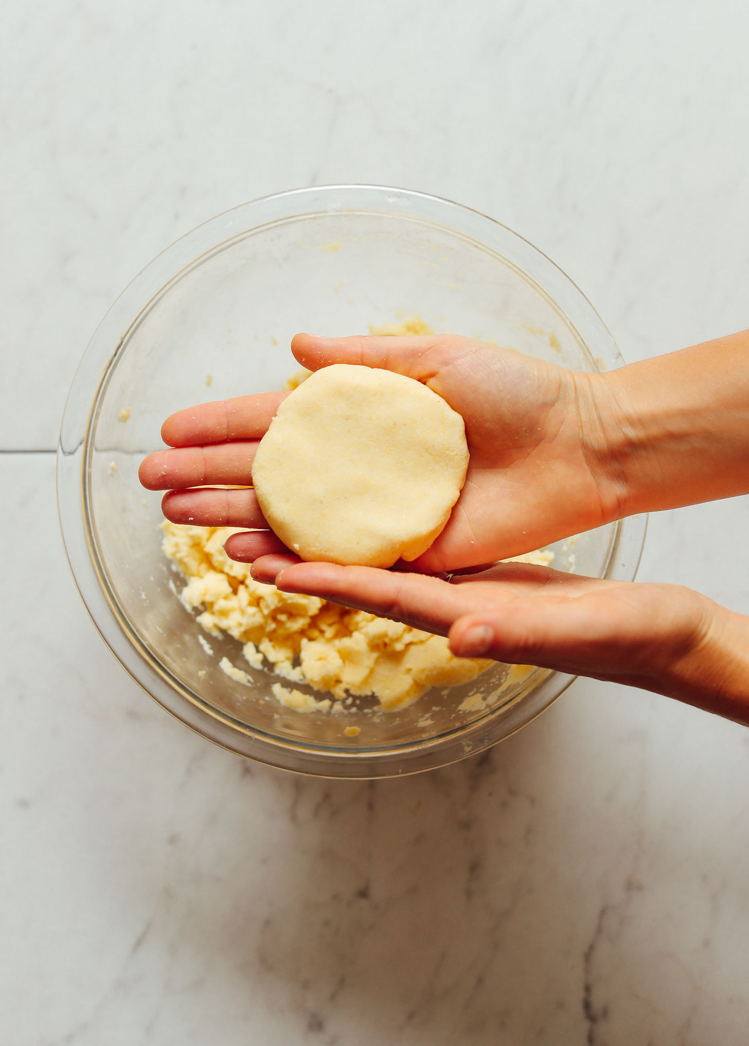Making arepa dough into a circle by shaping it with my hands