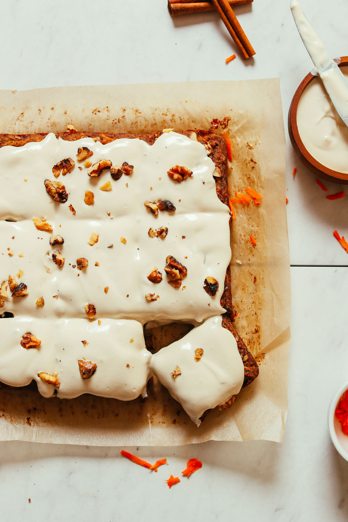 Carrot Apple Snack Cake resting on a piece of parchment paper