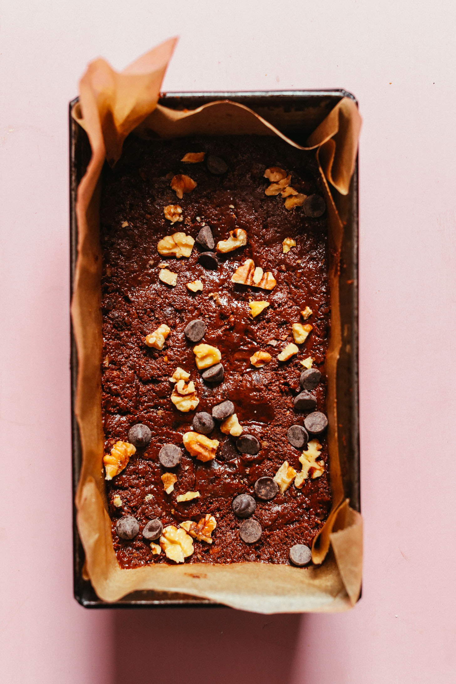Parchment-lined loaf pan filled with a batch of our easy vegan brownies