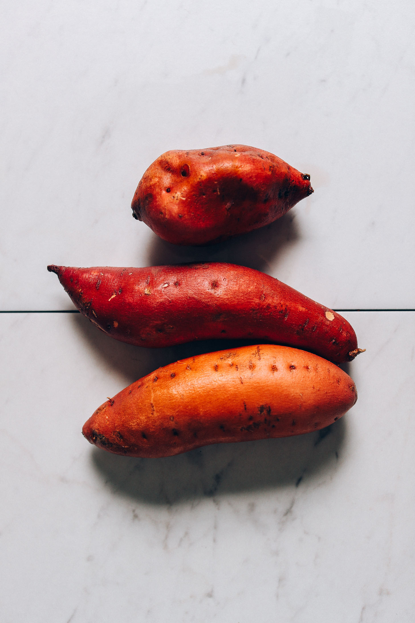Three sweet potatoes in different sizes