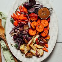 Platter of Pan Roasted Vegetables with a measuring cup of gravy