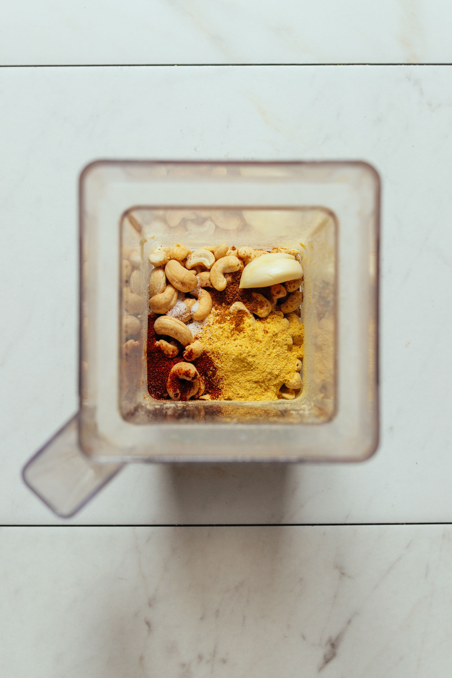 Overhead image of vegan cashew queso ingredients in a blender about to be blended