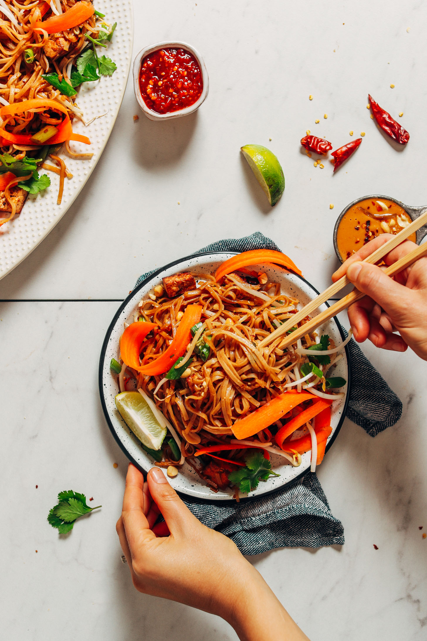 Using chopsticks to pick up a bite of Easy Vegan Pad Thai