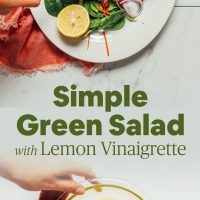 Platter of our Simple Green Salad with a bowl of homemade Lemon Vinaigrette Dressing