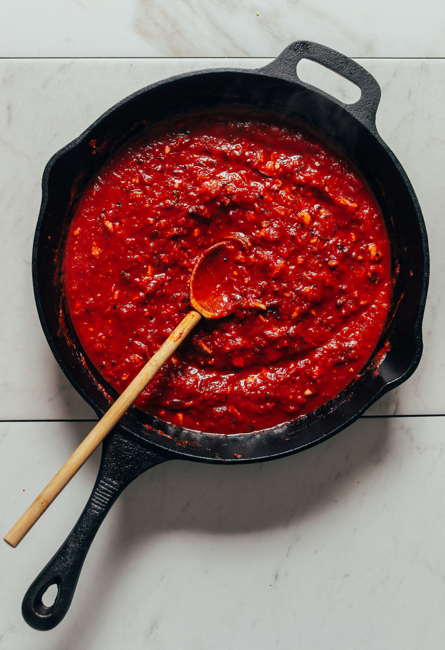 Cast-iron skillet filled with homemade vegan lasagna sauce