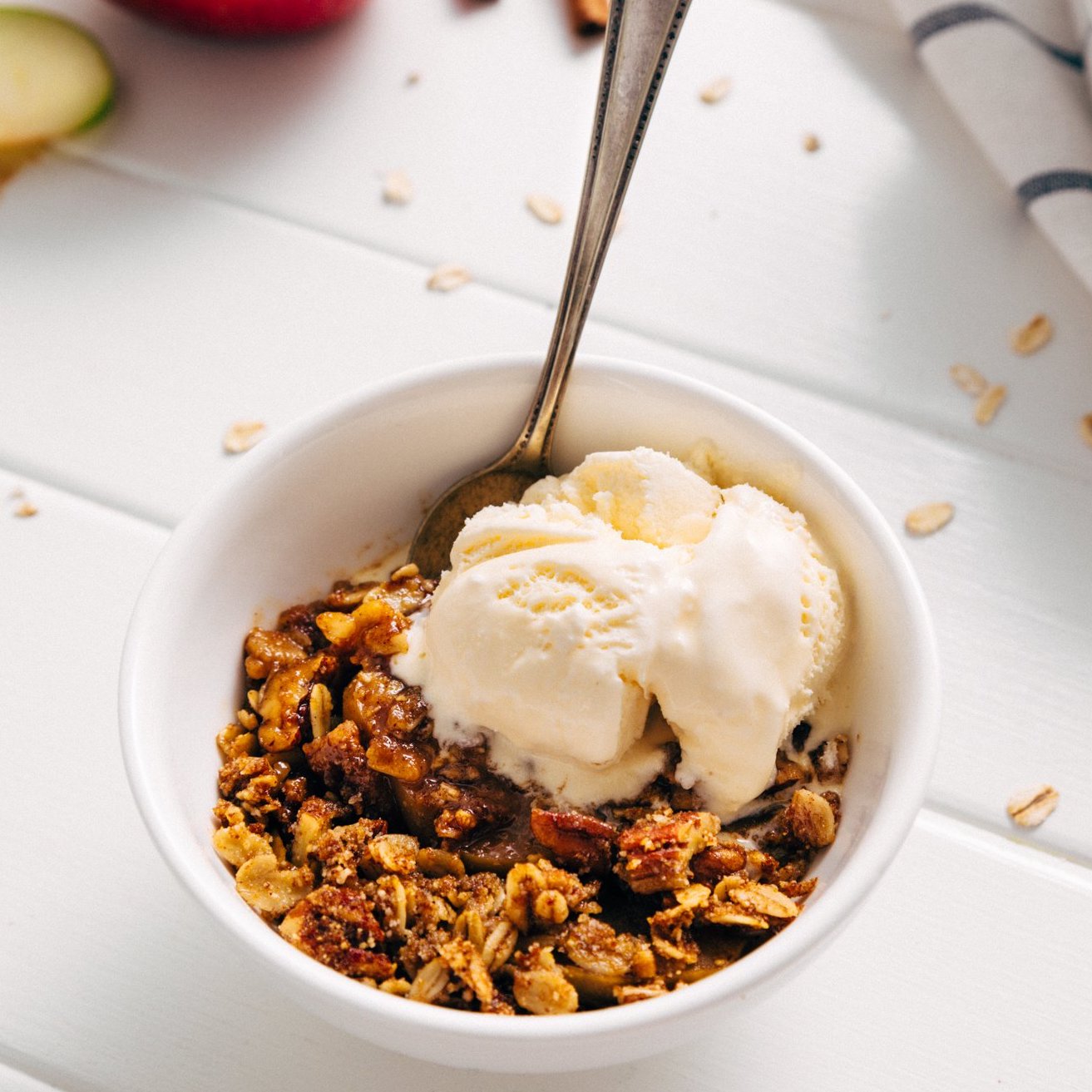 Bowl of Healthified Apple Crisp with vanilla ice cream