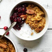 Bowl of Cranberry Pumpkin Oats with Coconut Whipped Cream