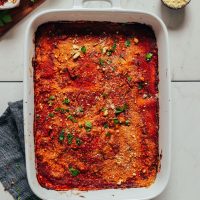 Baking dish of Easy Vegan Lasagna topped with chopped parsley