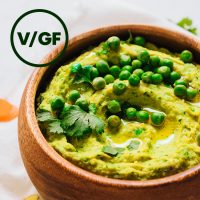 Bowl of Green Pea Curry Hummus overlaid with text