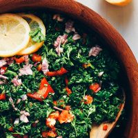 Bowl of Grain-Free Tabbouleh in a wood bowl with text overlaid saying 16 Raw Plant-Based Recipes