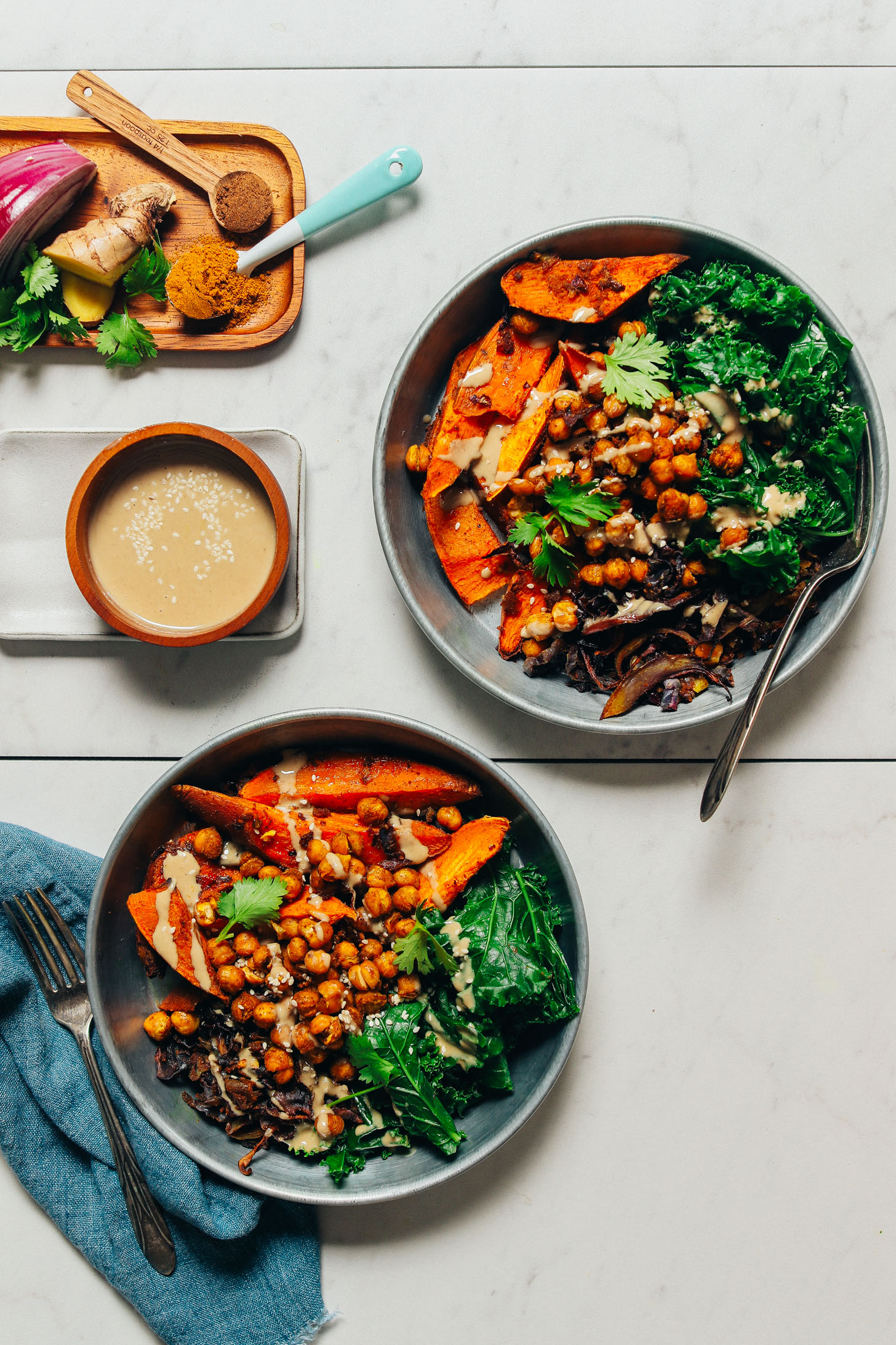 Two bowls of our Sweet Potato and Chickpea Sheet Pan Meal for a simple and delicious vegan dinner
