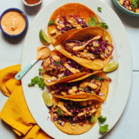Large platter filled with dairy-free Grilled Fish Tacos topped with Pineapple Cabbage Slaw