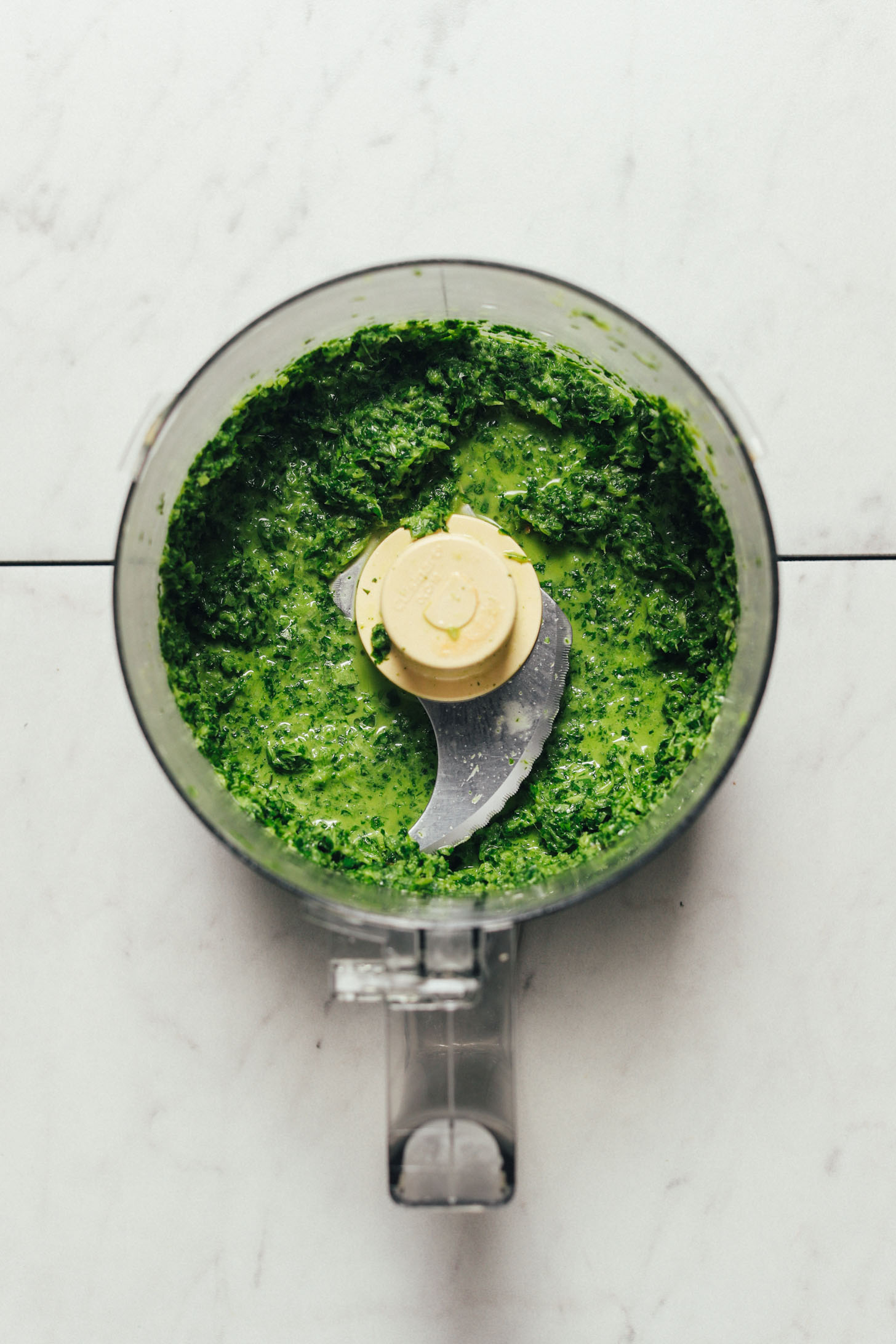 Food processor with freshly blended green sauce for making Mexican-inspired Cauliflower Green Rice