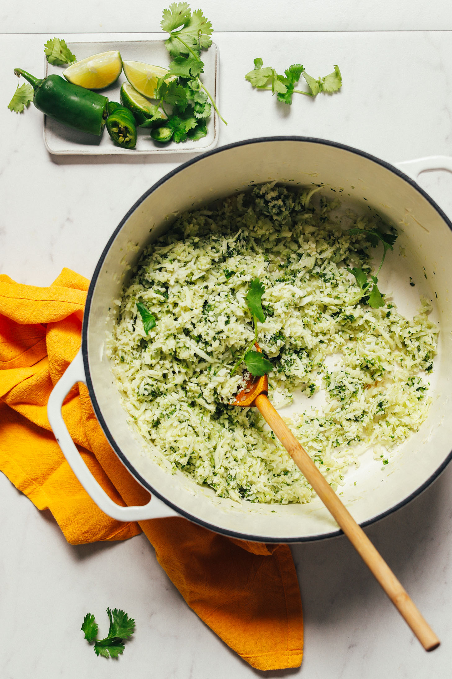Pot of our Cauliflower Green Rice recipe made with lime, herbs, and peppers