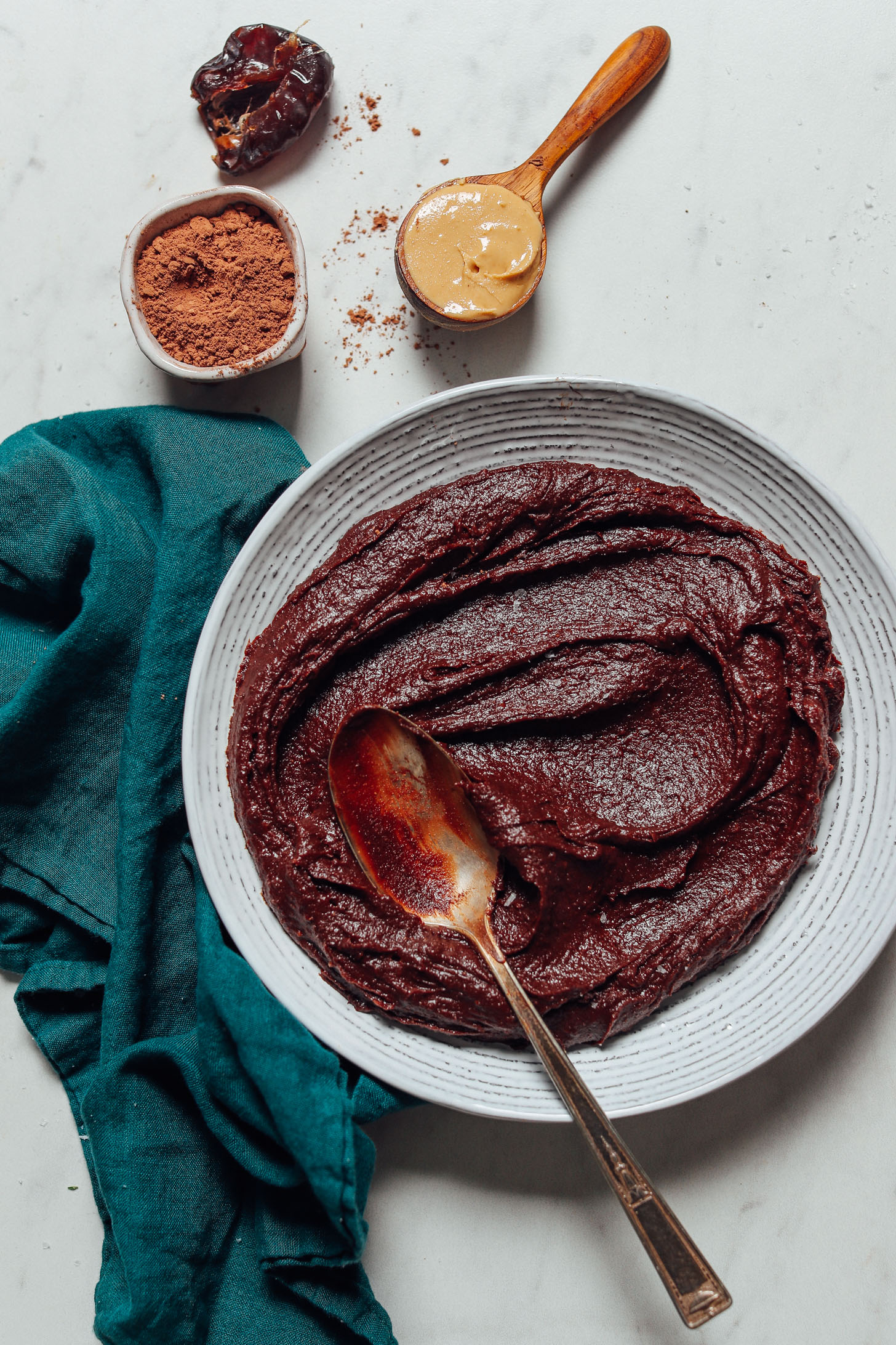Spoon in a bowl of gluten-free Vegan Chocolate Frosting