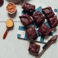 Brownies topped with creamy Vegan Chocolate Frosting made with dates