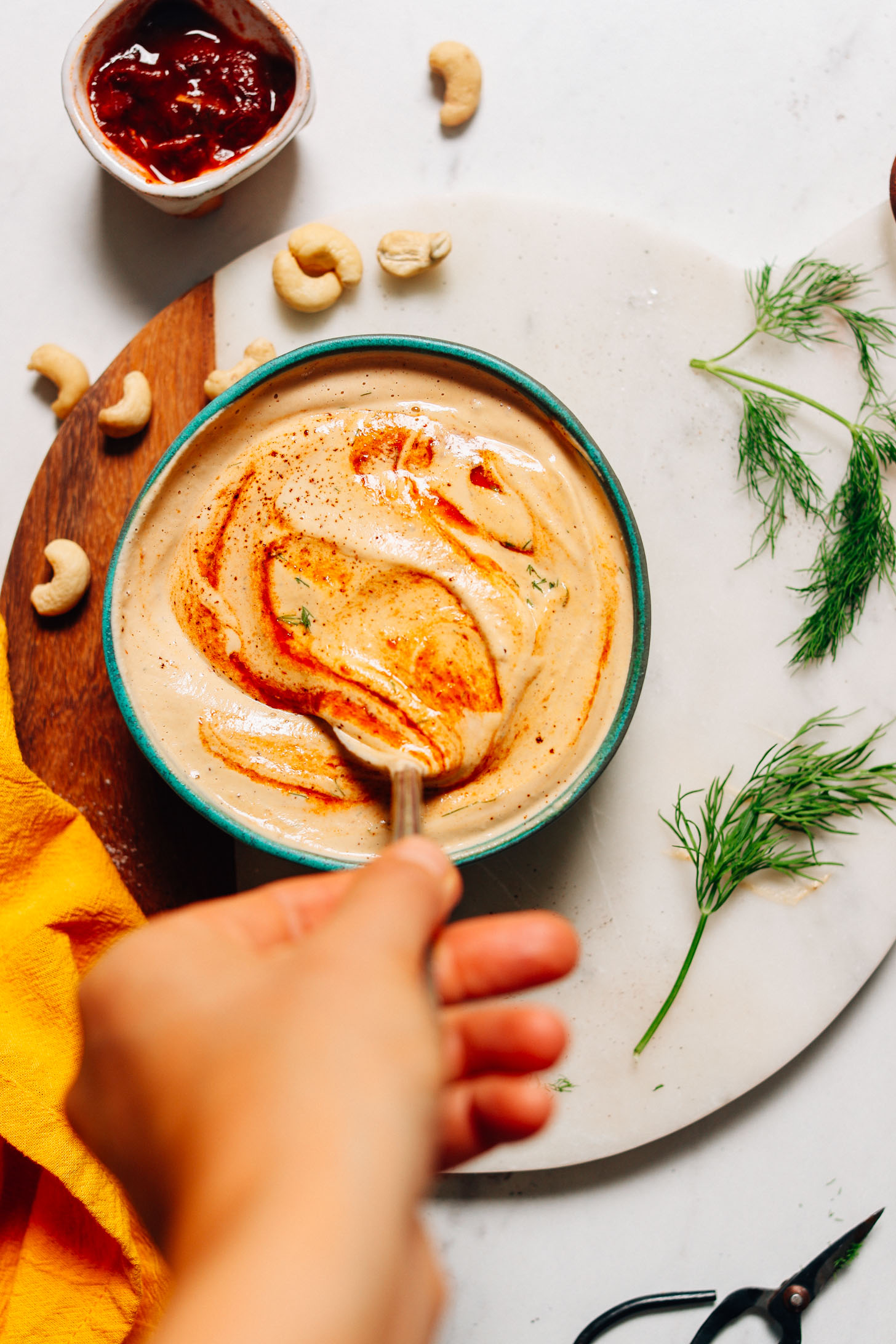 Stirring a bowl of our Vegan Chipotle Ranch Dressing recipe
