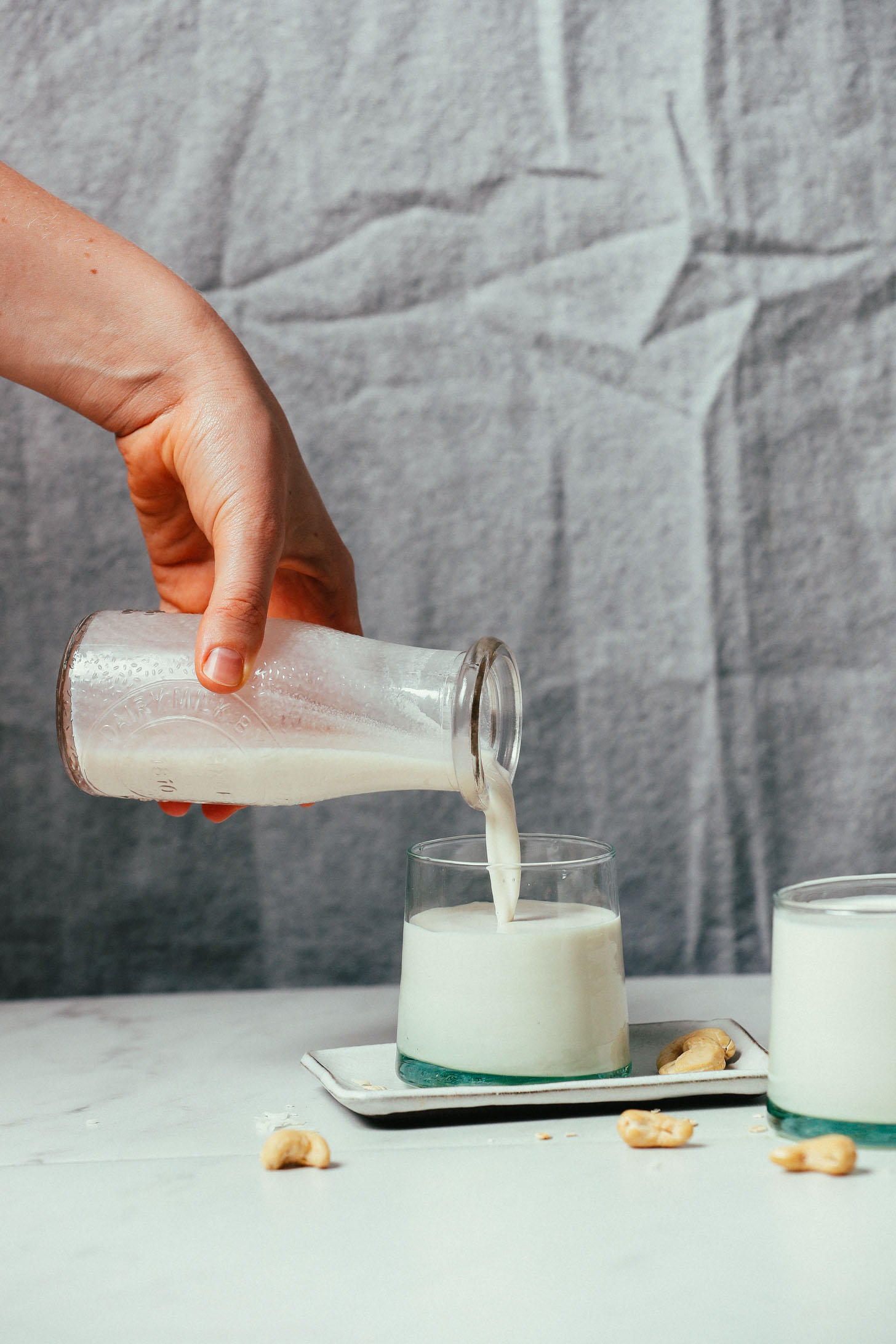Pouring our Creamy Oat Milk that froths into a glass