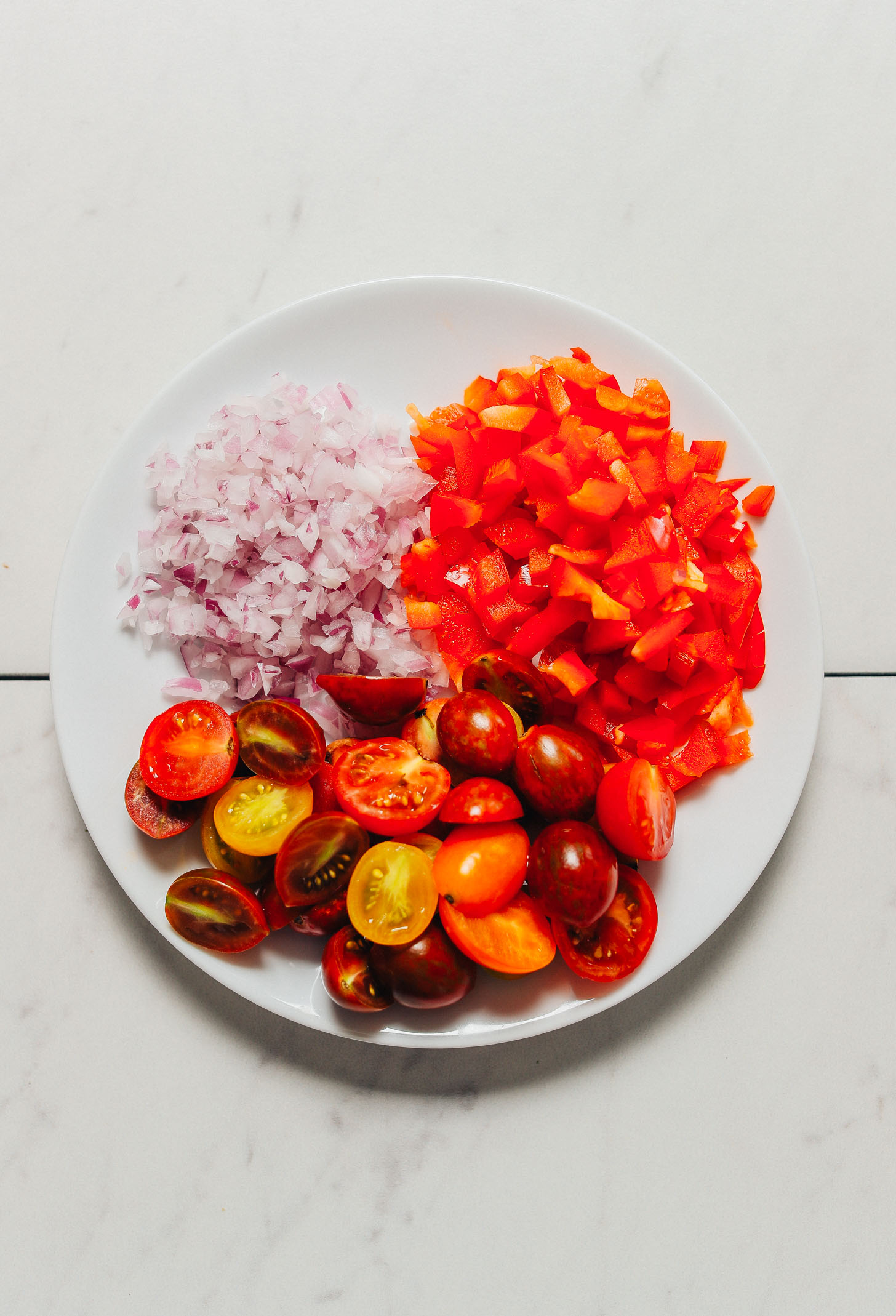 Plate of diced vegetables for making our vegan Grilled Corn Salad recipe