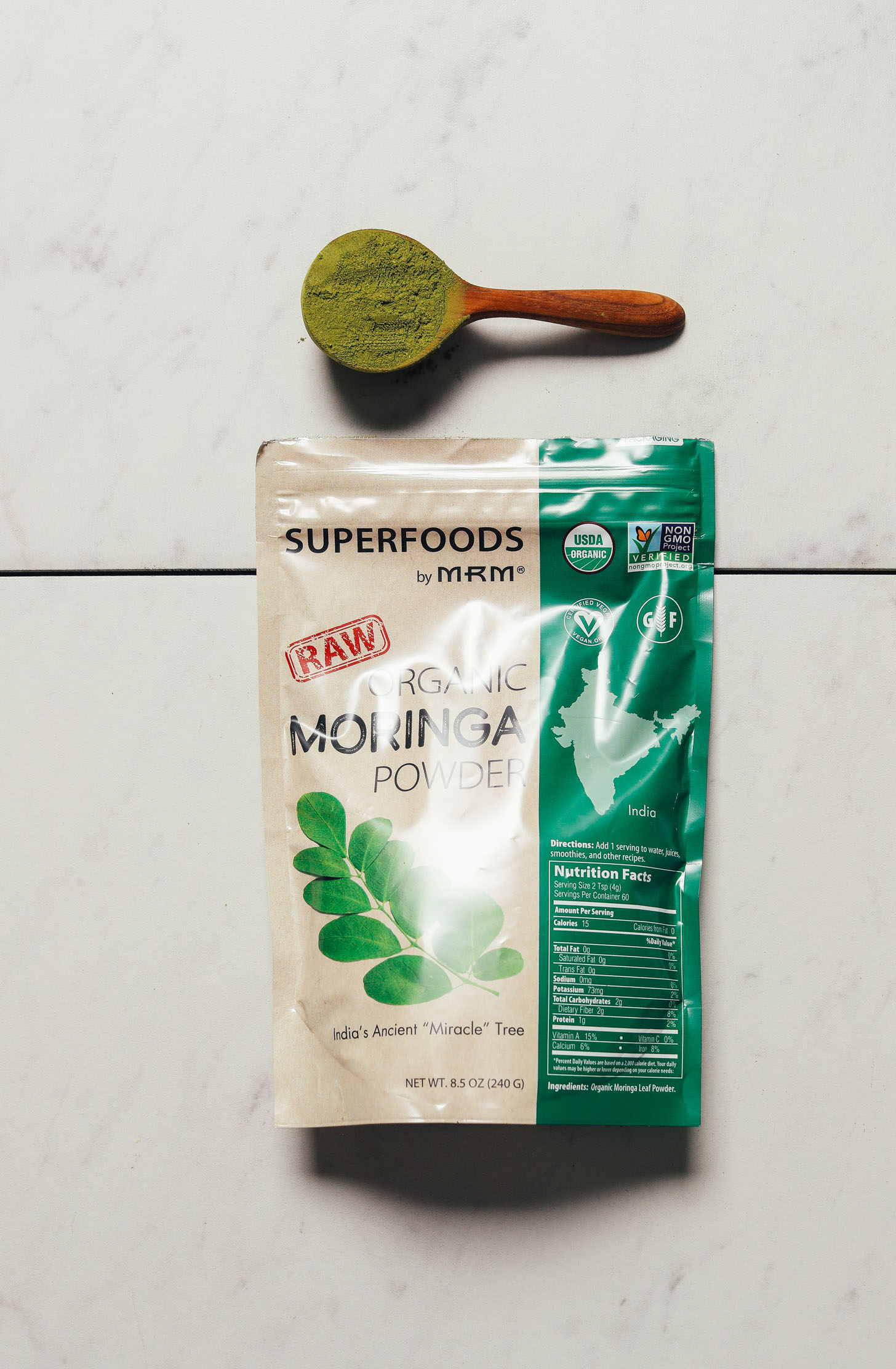 Bag and spoonful of MRM Superfoods Moringa Powder for our review of the best moringa brands