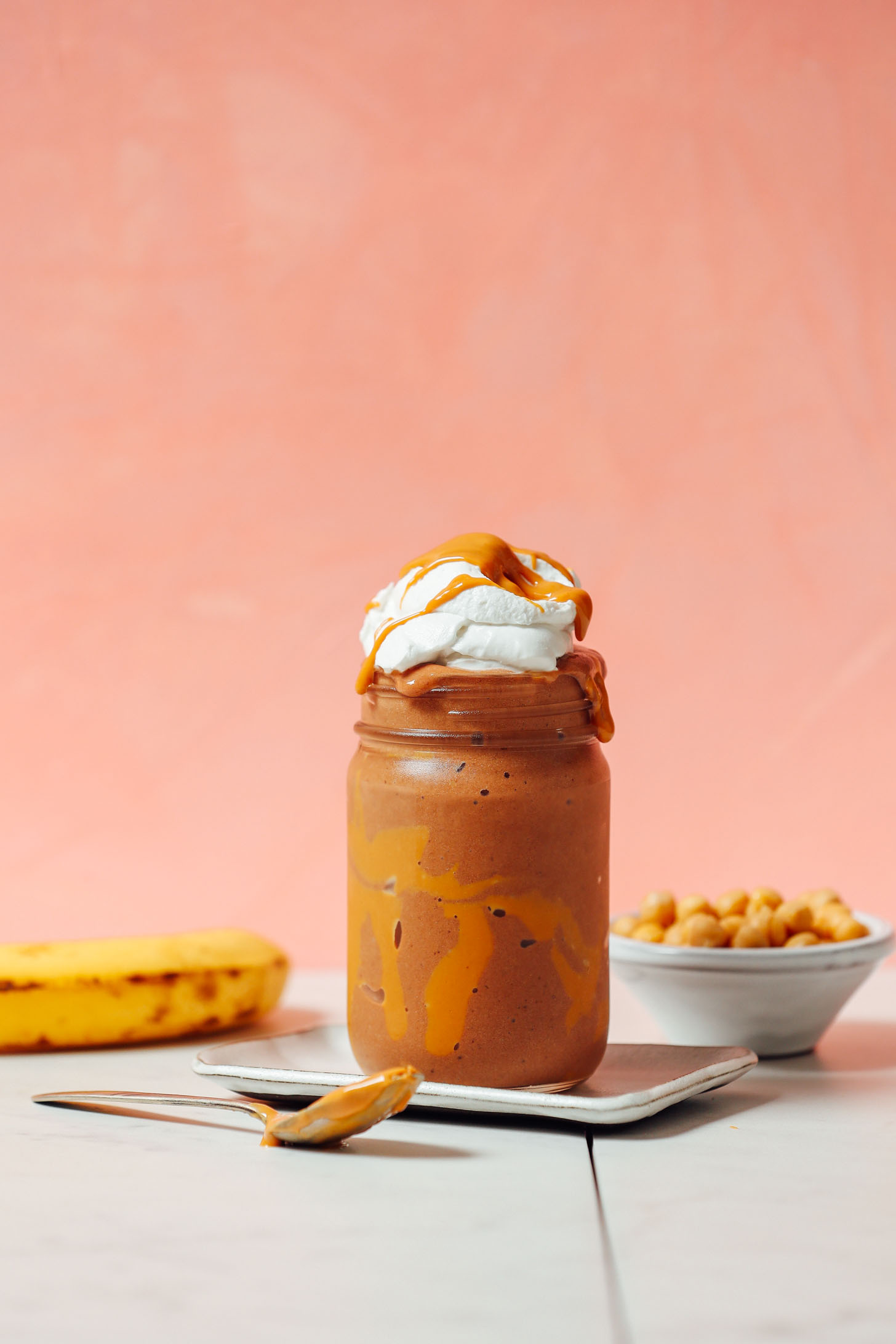 Glass jar filled with our Peanut Butter Chocolate Shake made with chickpeas