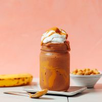 Peanut Butter Chocolate Chickpea Shake topped with coconut whipped cream