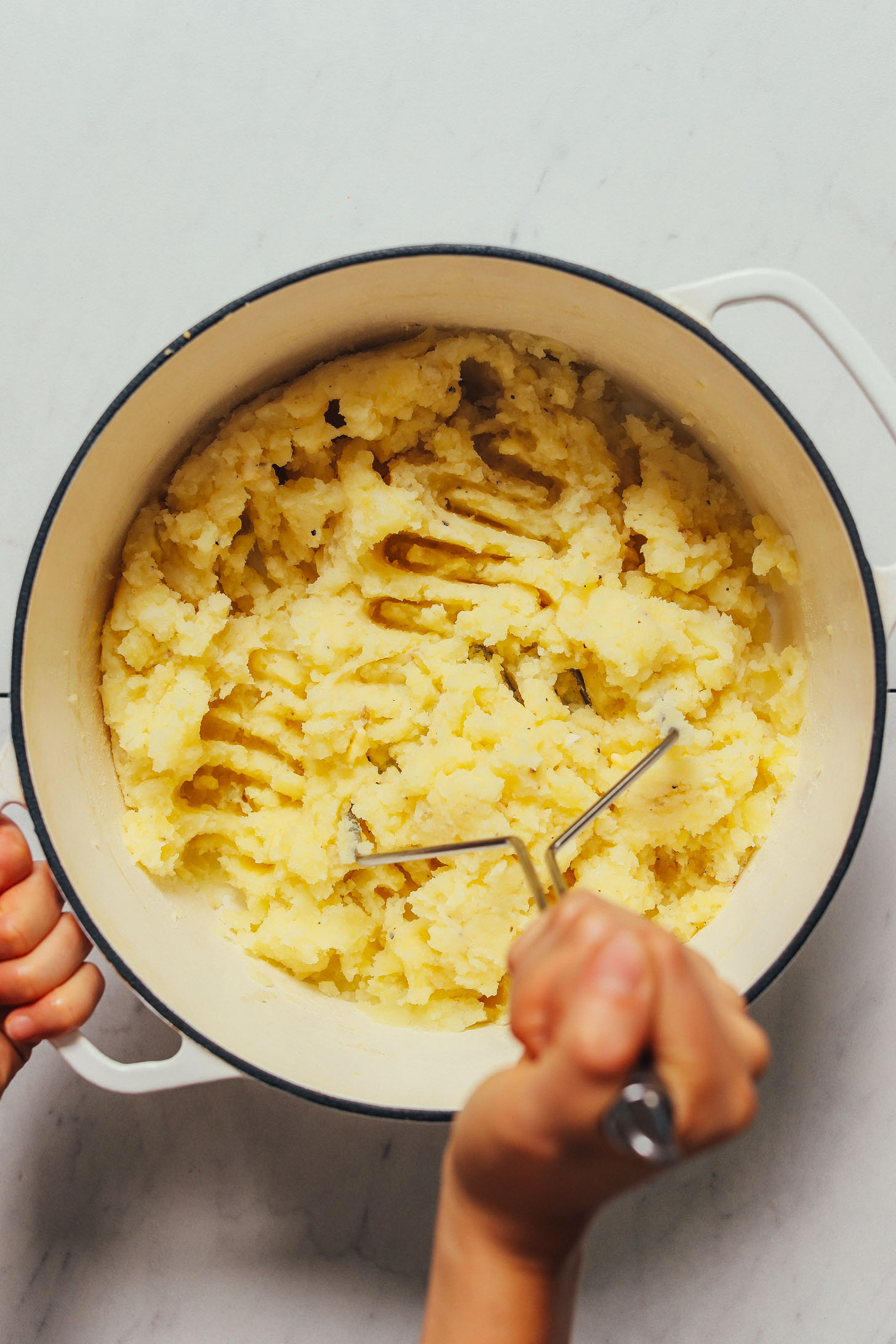 Using a potato masher to make homemade mashed potatoes