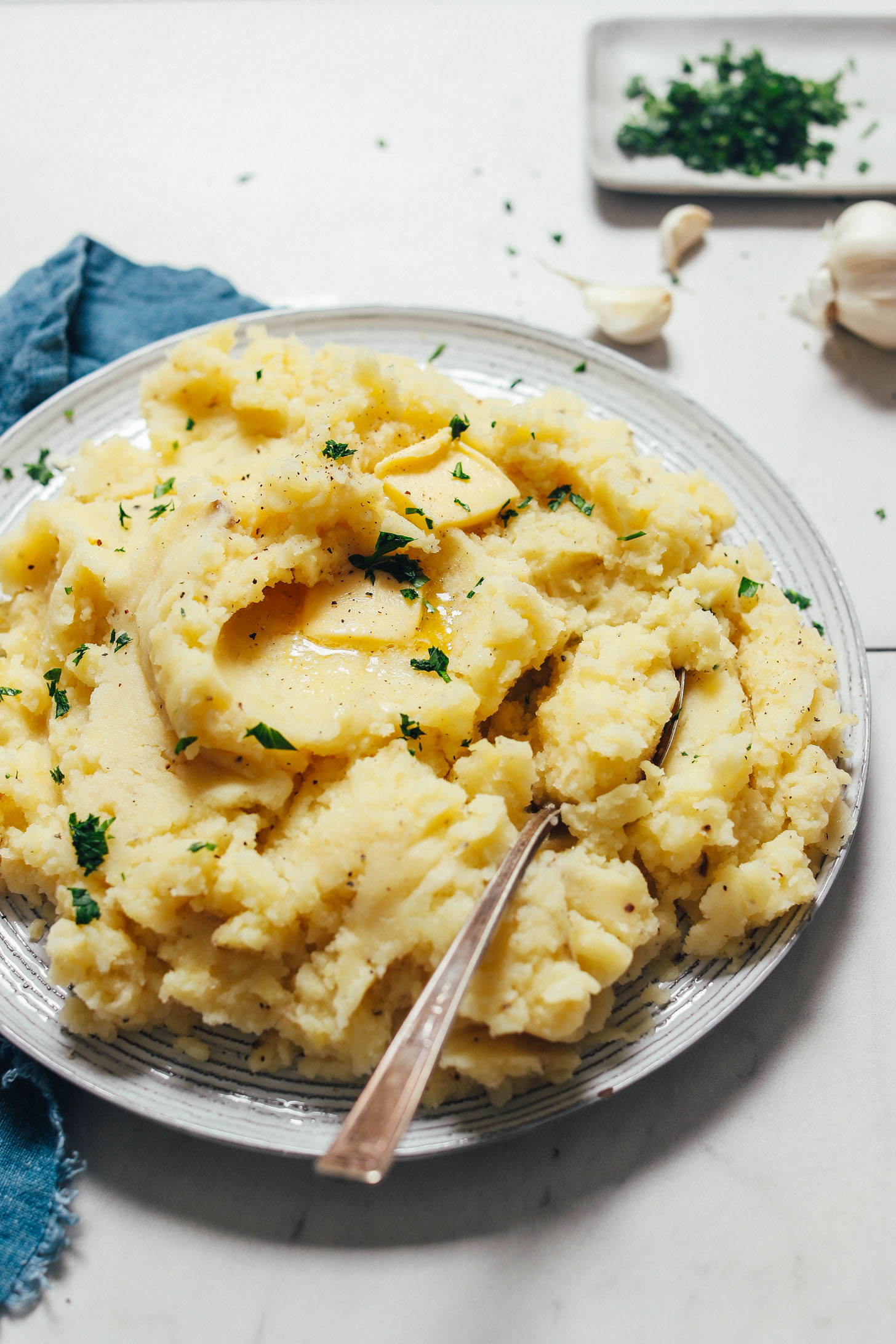 Plate of easy Vegan Mashed Potatoes topped with fresh parsley