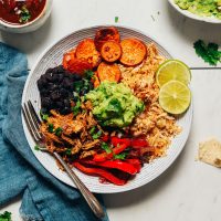 Fork resting in a Grain-Free Burrito Bowl topped with guacamole