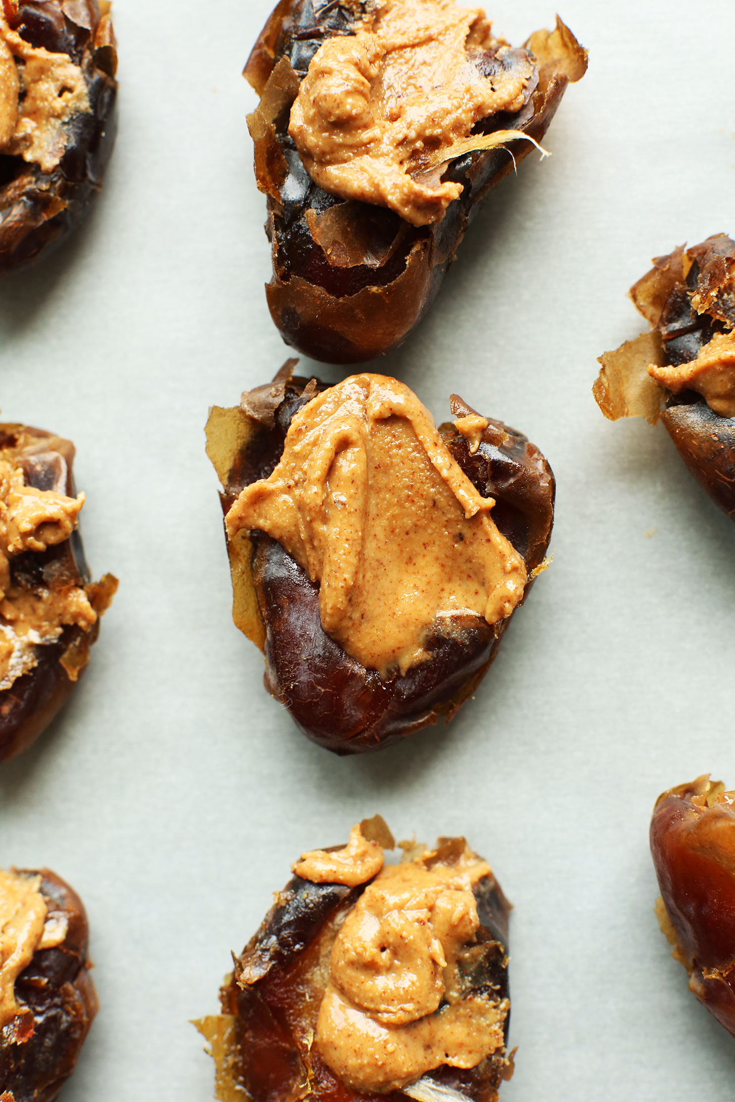 Dates stuffed with almond butter for making Vegan Chocolate Snowballs