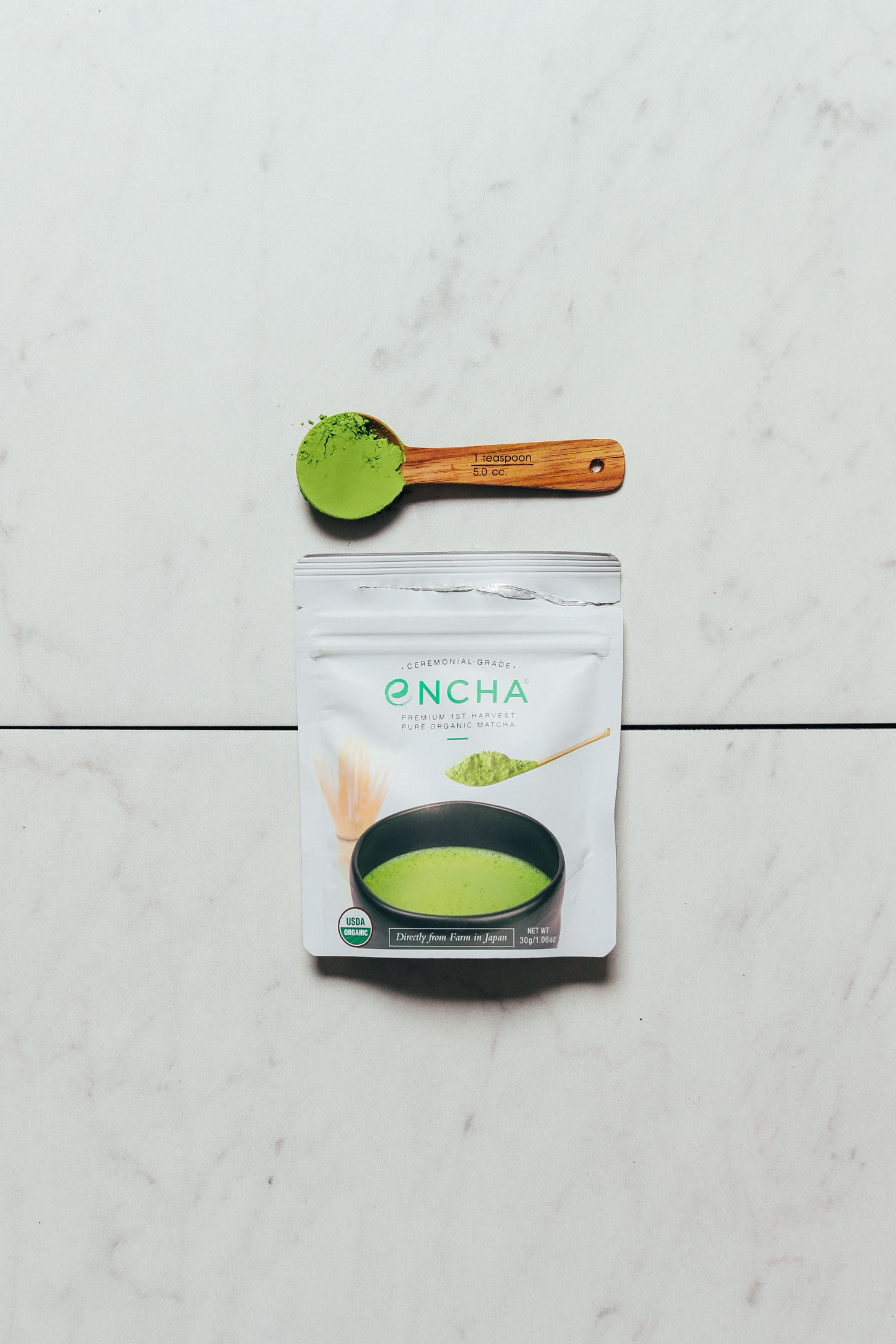 Spoonful and packet of Encha matcha powder for our review of the best brands of matcha