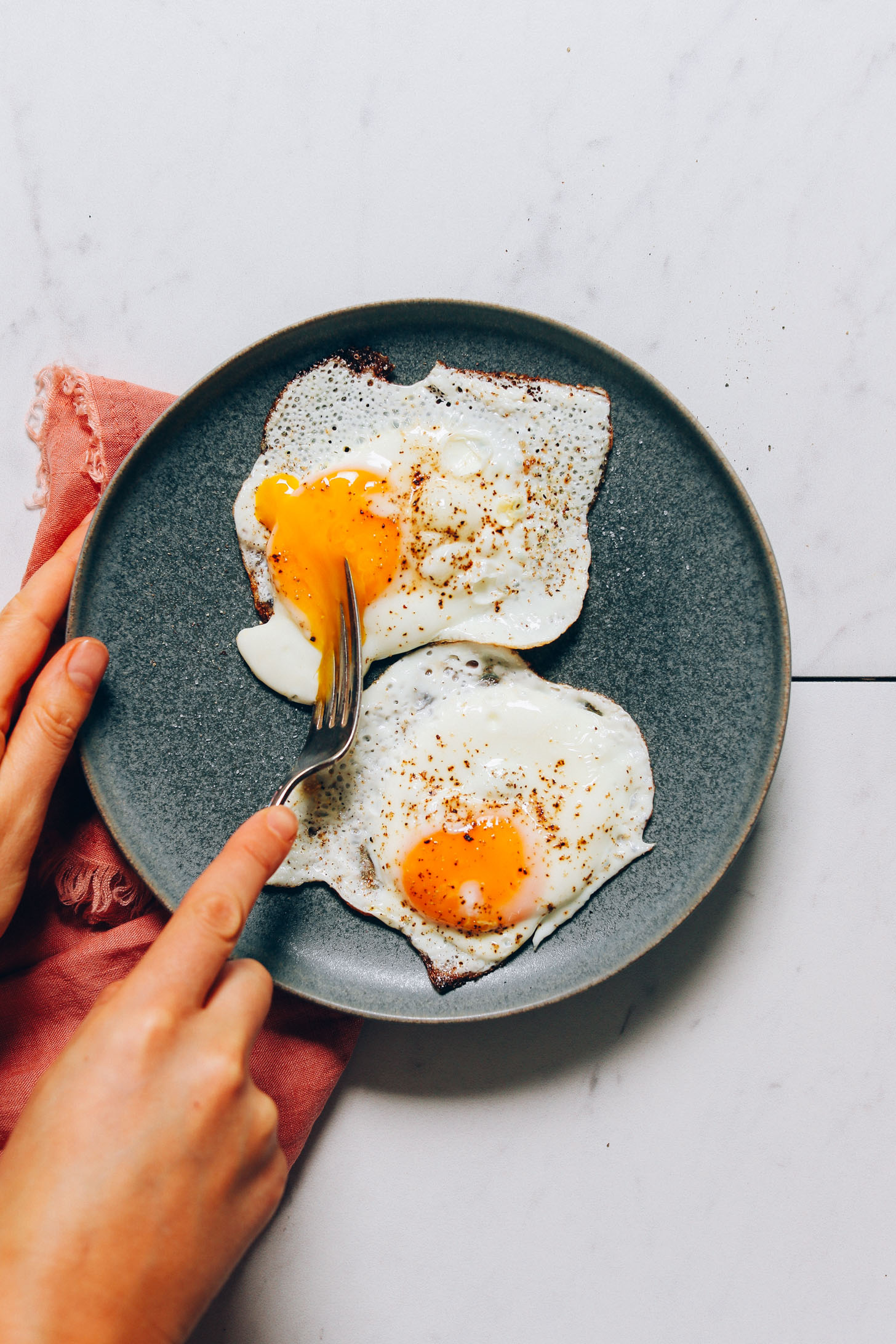 Plate of perfectly cooked sunny side up eggs for our tutorial on How to Cook an Egg