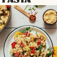 Plate of creamy vegan white pasta with summer vegetables